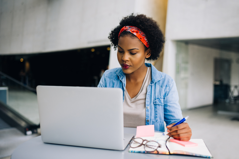 Young,African,Female,Entrepreneur,Sitting,At,A,Table,In,A